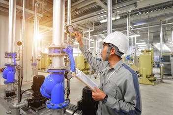 worker checking a used air compressor