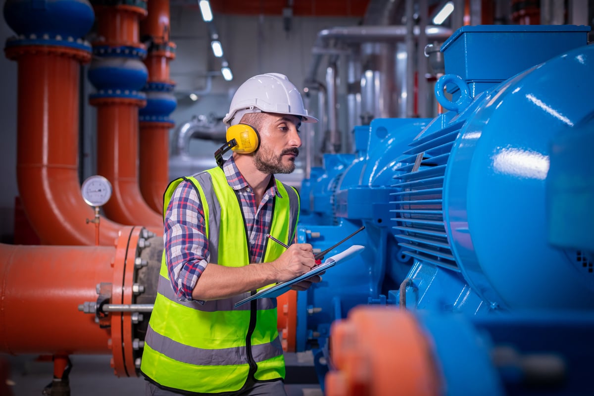 man inspecting air compressor