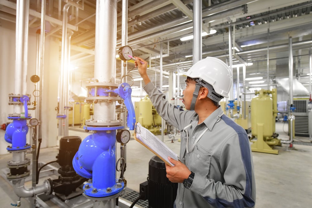 worker checking a used air compressor
